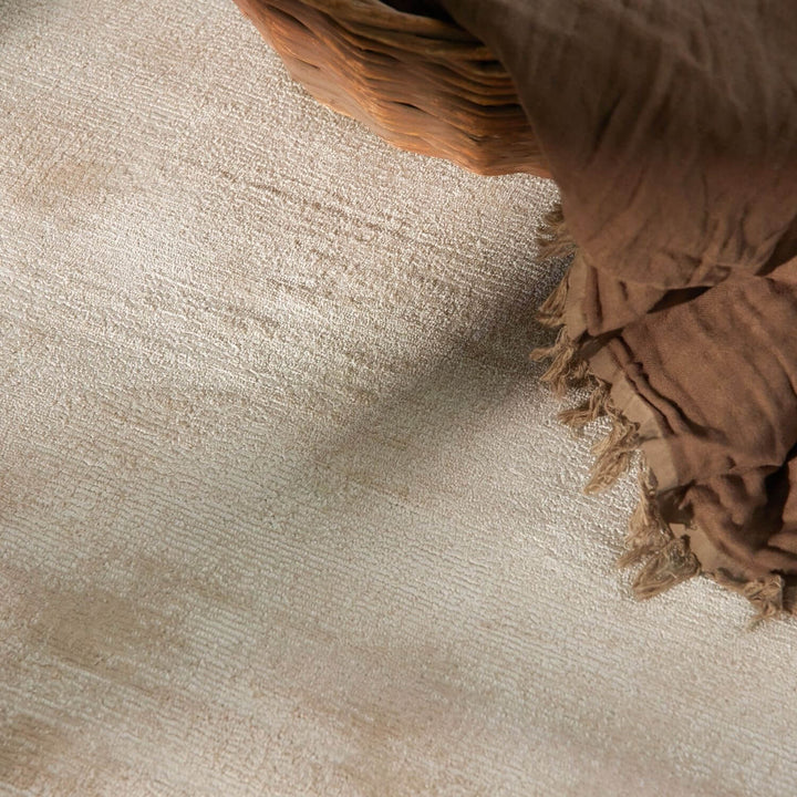 Brown woven basket on a textured beige surface