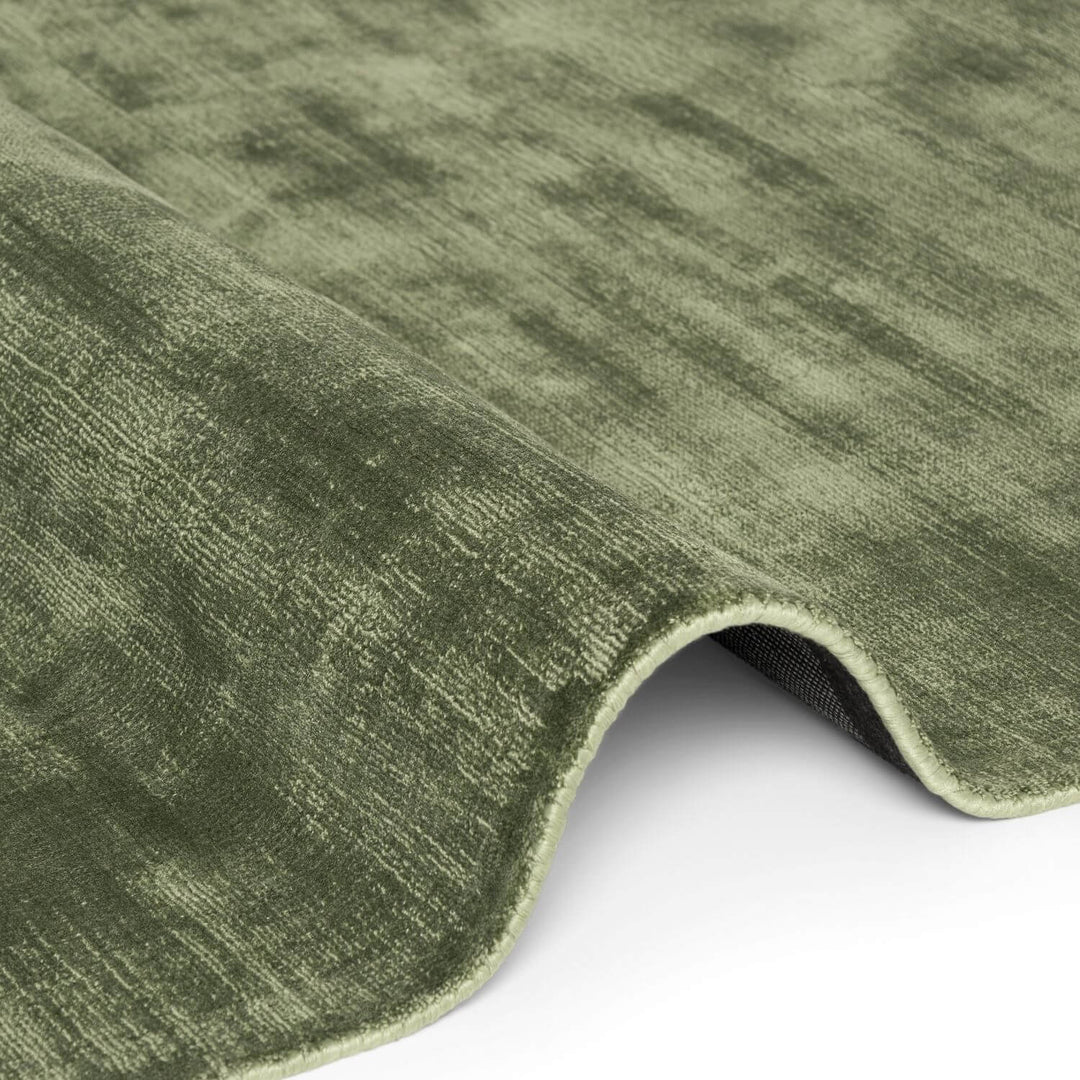Close-up of a green textured rug on a white background