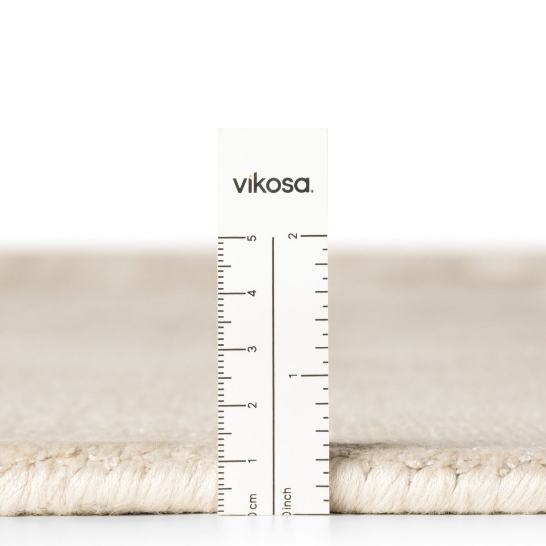 Beige fabric swatch with a ruler and 'vikosa' branding