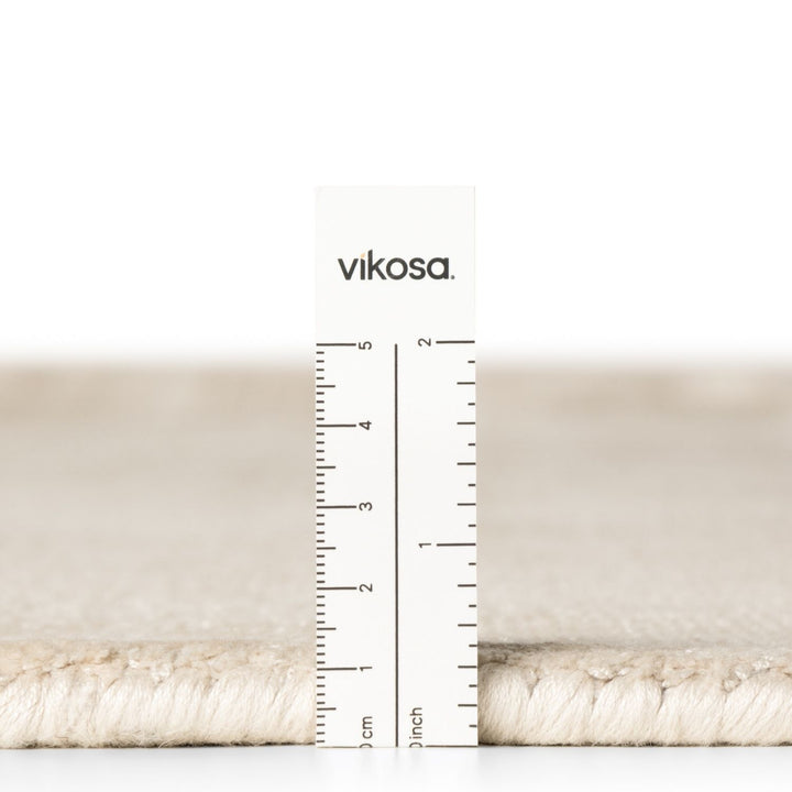 Beige fabric swatch with a ruler and 'vikosa' branding