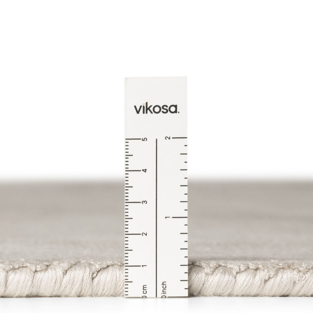 Vikosa yarn with a ruler for measurement on a white background