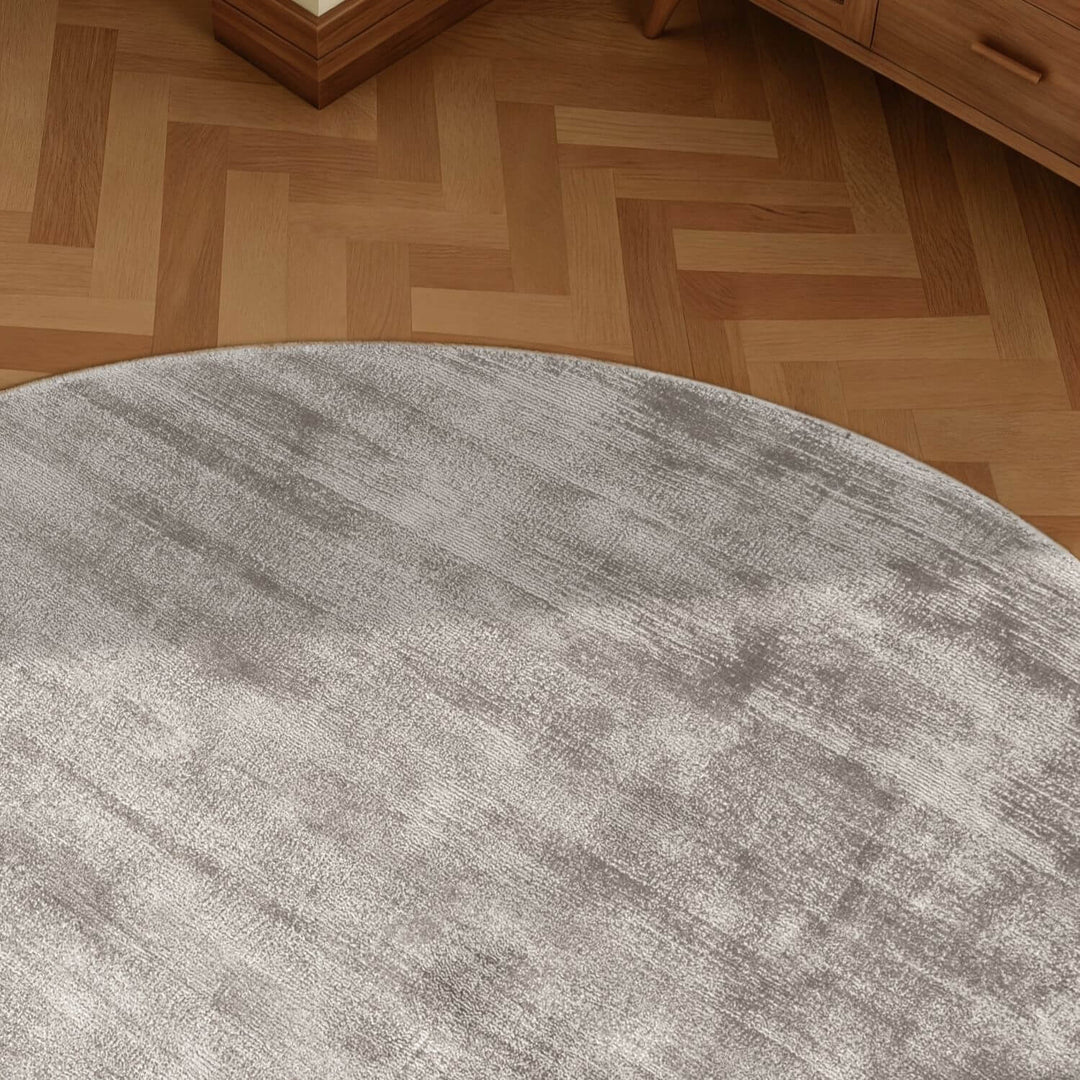 Round gray rug on a wooden floor