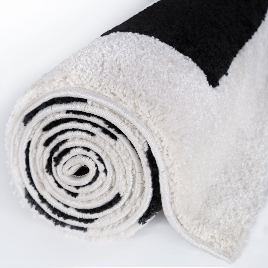 Rolled-up white towel with black stripe on a white background
