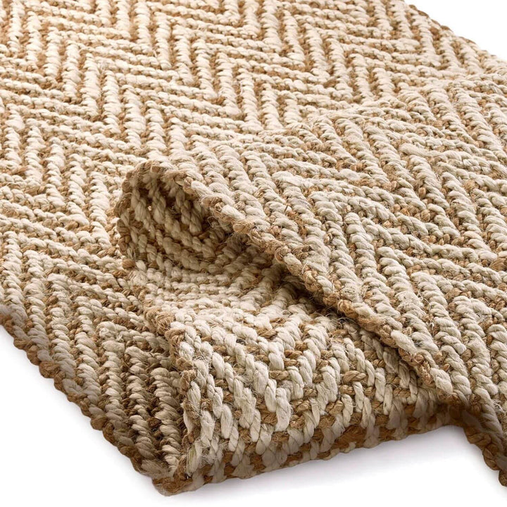 Textured beige rug with a woven pattern on a white background