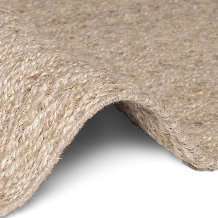 Close-up of a textured beige fabric with a white background