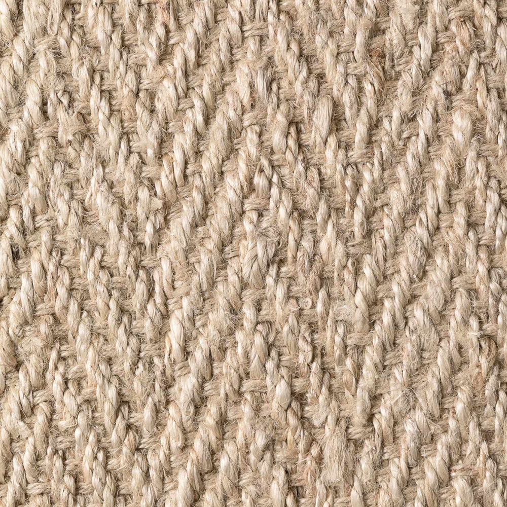 Close-up of a textured beige fabric with a woven pattern