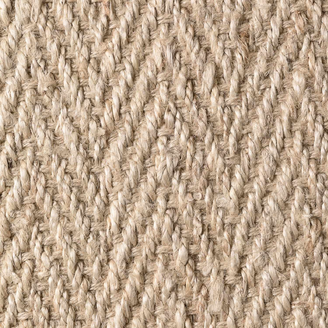 Close-up of a textured beige fabric with a woven pattern