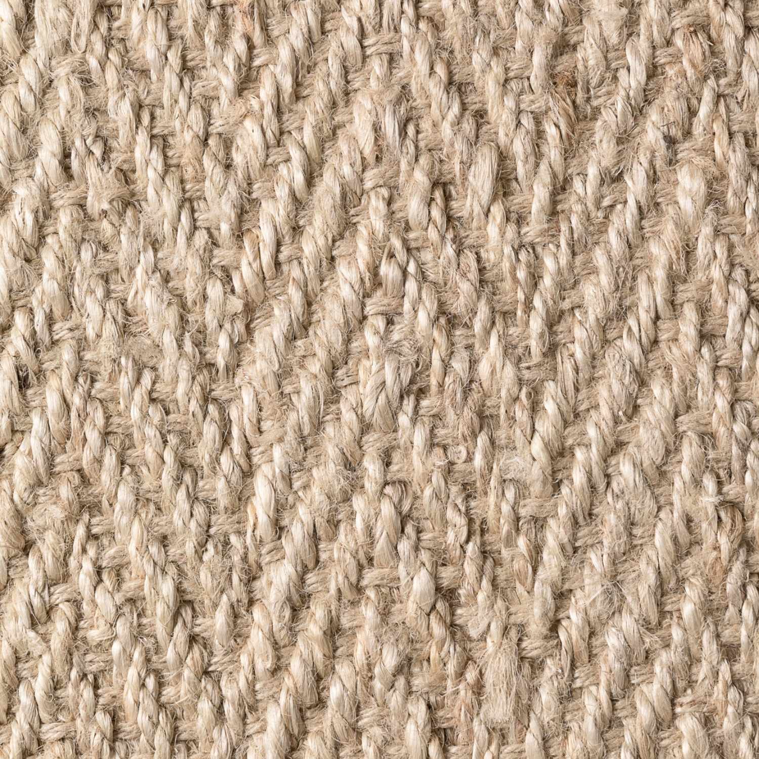 Close-up of a textured beige fabric with a woven pattern