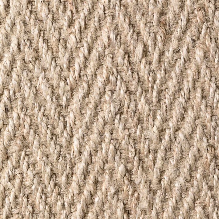 Close-up of a textured beige fabric with a woven pattern