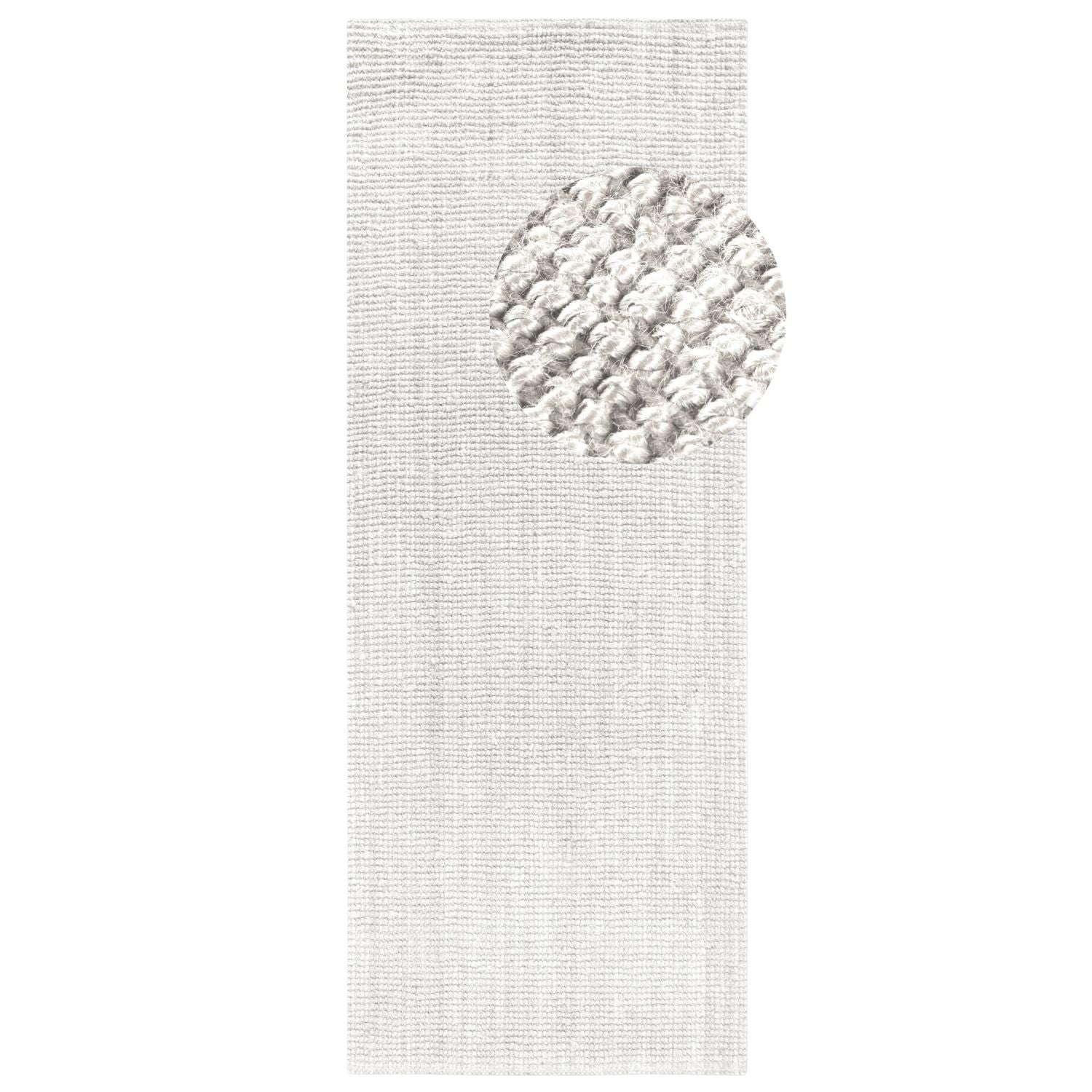 Textured white rug with a circular pattern on a plain background