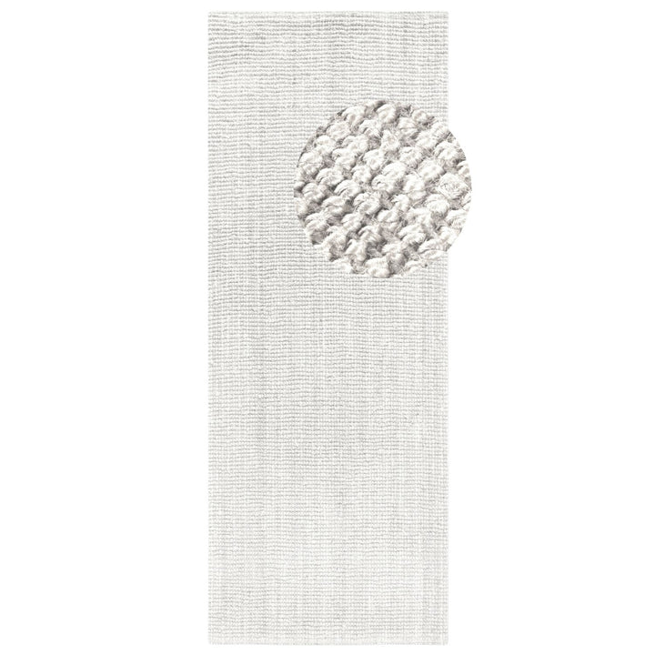 Textured white rug with a circular pattern on a plain background