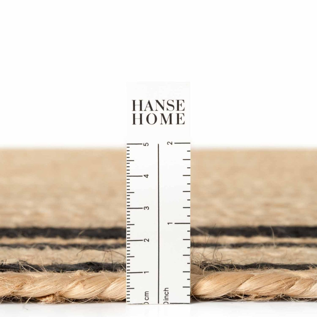 Close-up of woven material with a ruler and 'Hanse Home' branding.