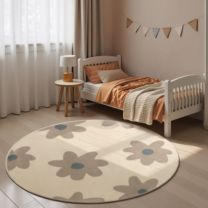 Children's bedroom with a round floral rug, bed, and side table.