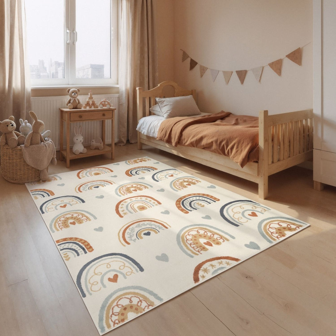 Children's room with a bed, toys, and a colorful rug featuring rainbows and hearts.