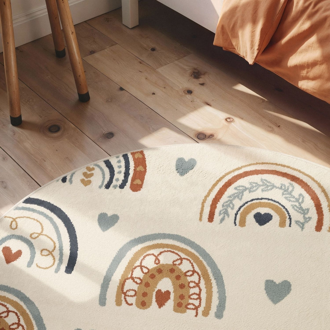 Decorative rug with rainbow and heart patterns on a wooden floor.