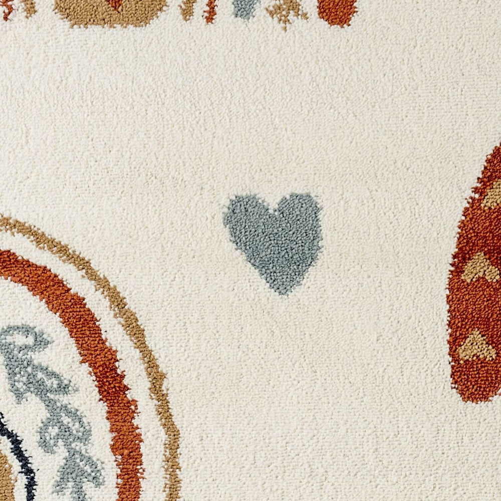 Close-up of a textured surface with heart and circular patterns in various colors on a beige background.