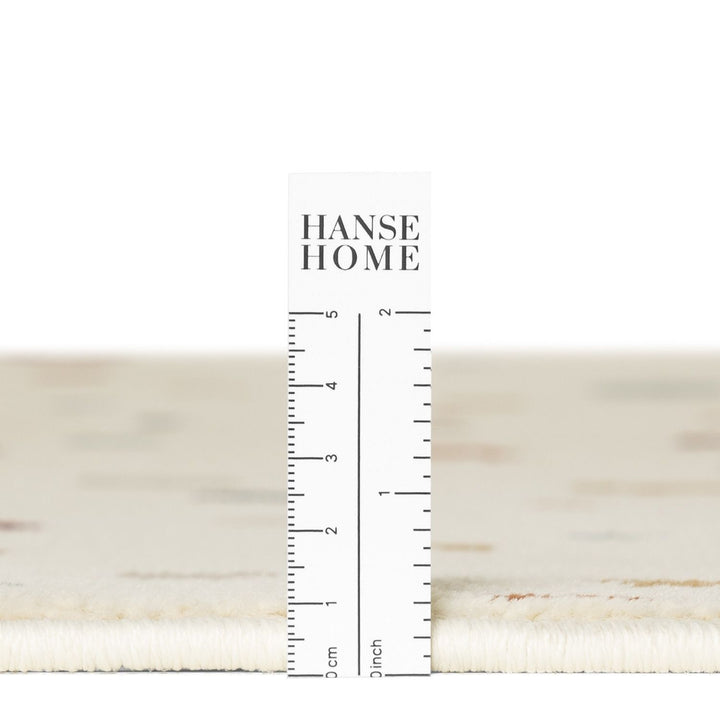 Close-up of a textured fabric swatch with a ruler and 'HANSE HOME' branding.