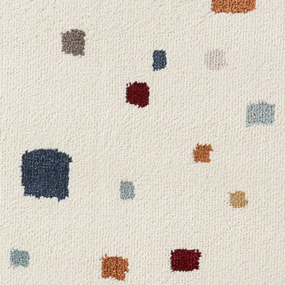 Patterned rug with multicolored square shapes on a beige background
