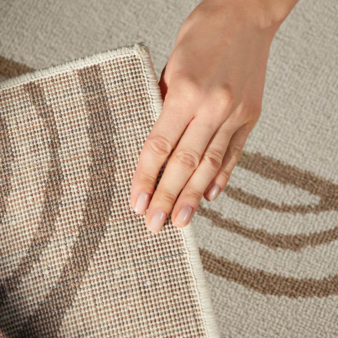 Hand touching a textured fabric surface