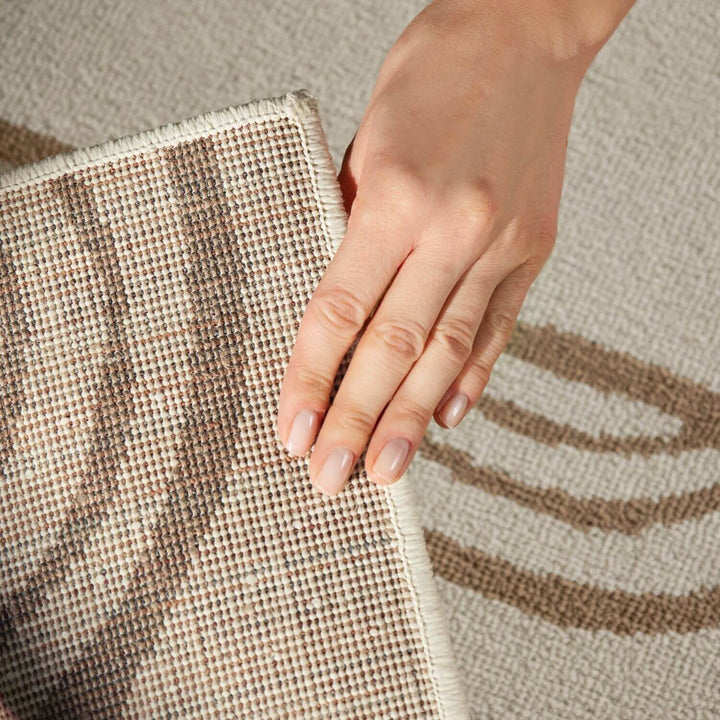 Hand touching a textured fabric surface
