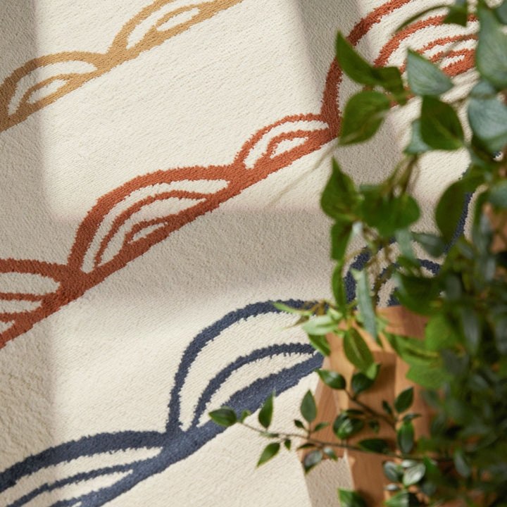 Textile with leaf pattern and green plant