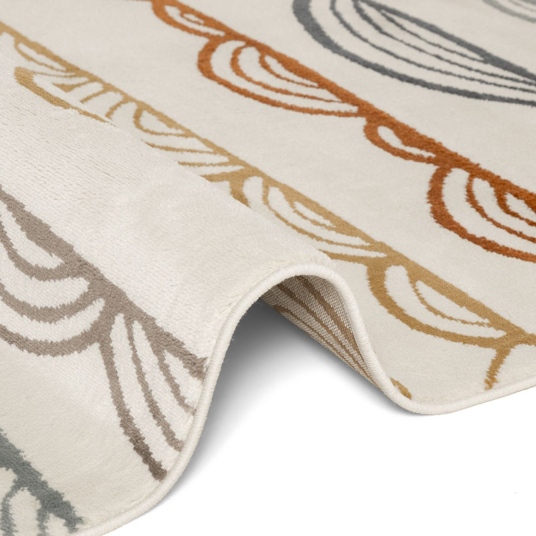 Close-up of a textured rug with leaf patterns in brown, beige, and gray on a white background.