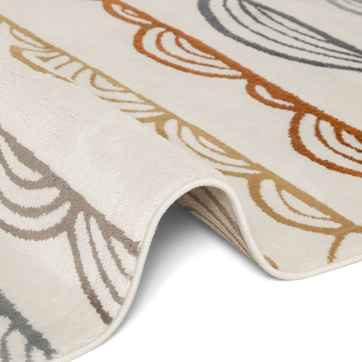 Close-up of a textured rug with leaf patterns in brown, beige, and gray on a white background.