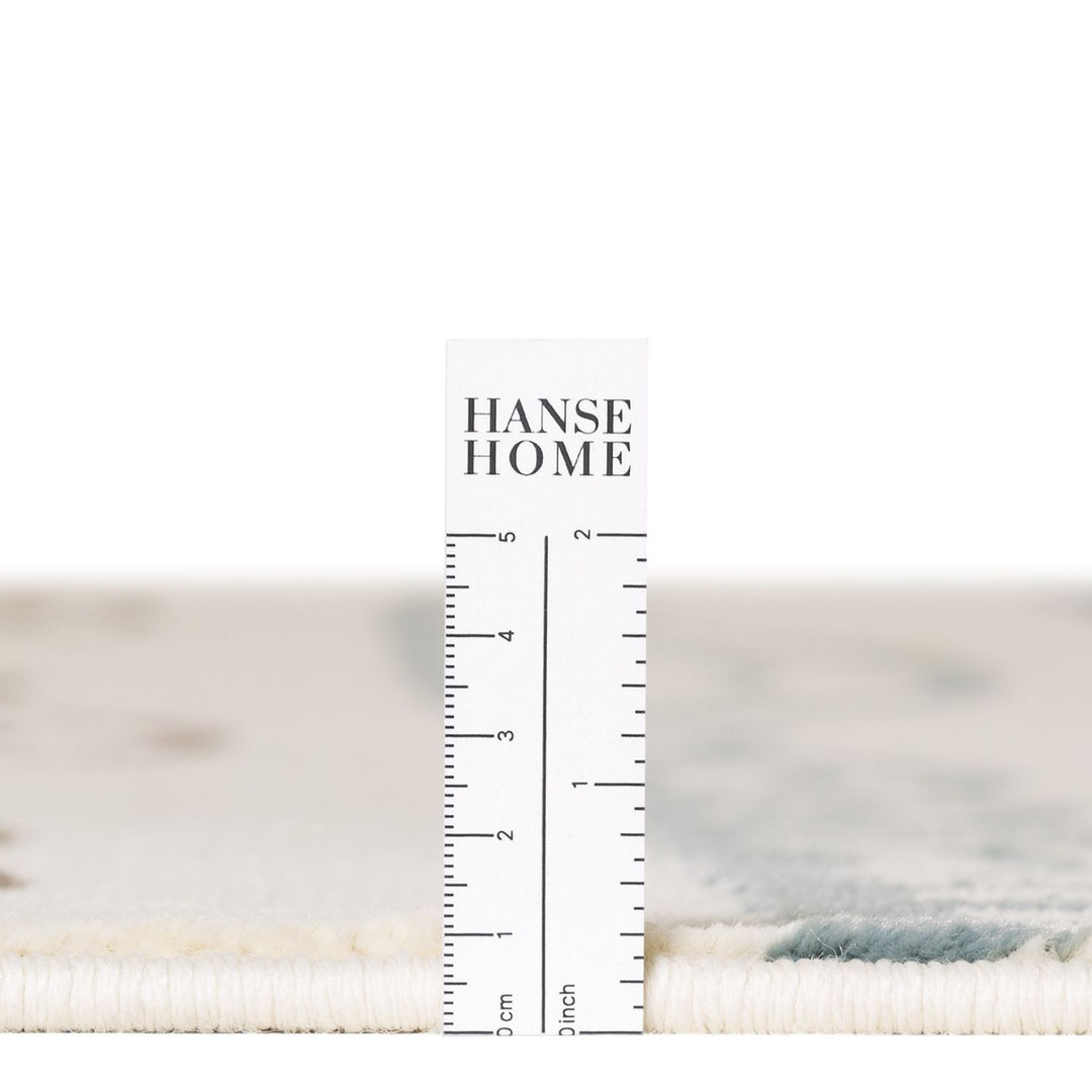 Textile sample with a ruler for measurement and 'HANSE HOME' branding.