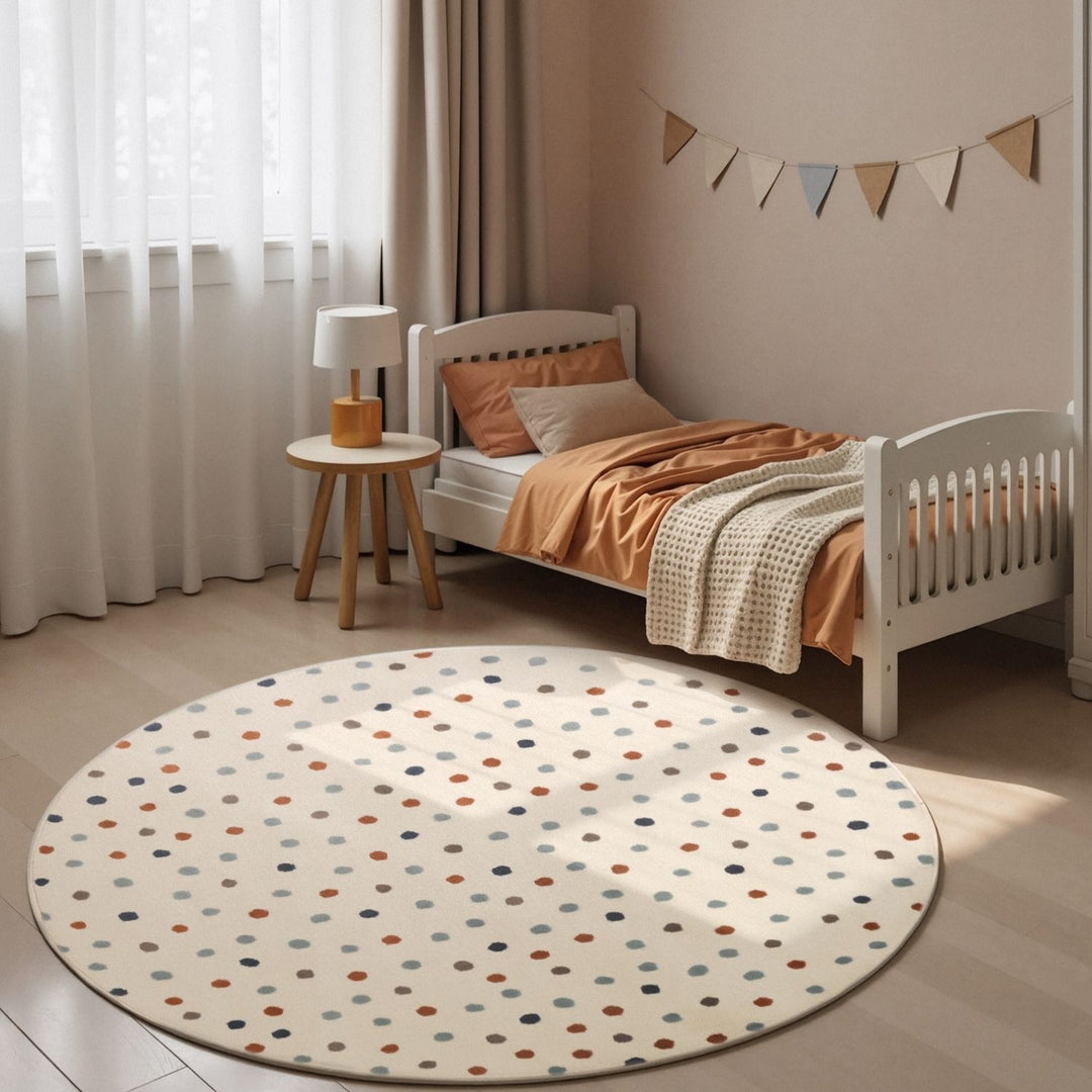 Children's bedroom with a polka dot rug, bed, and small table.