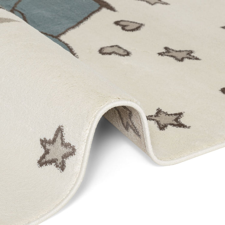 Close-up of a textured rug with star patterns on a neutral background