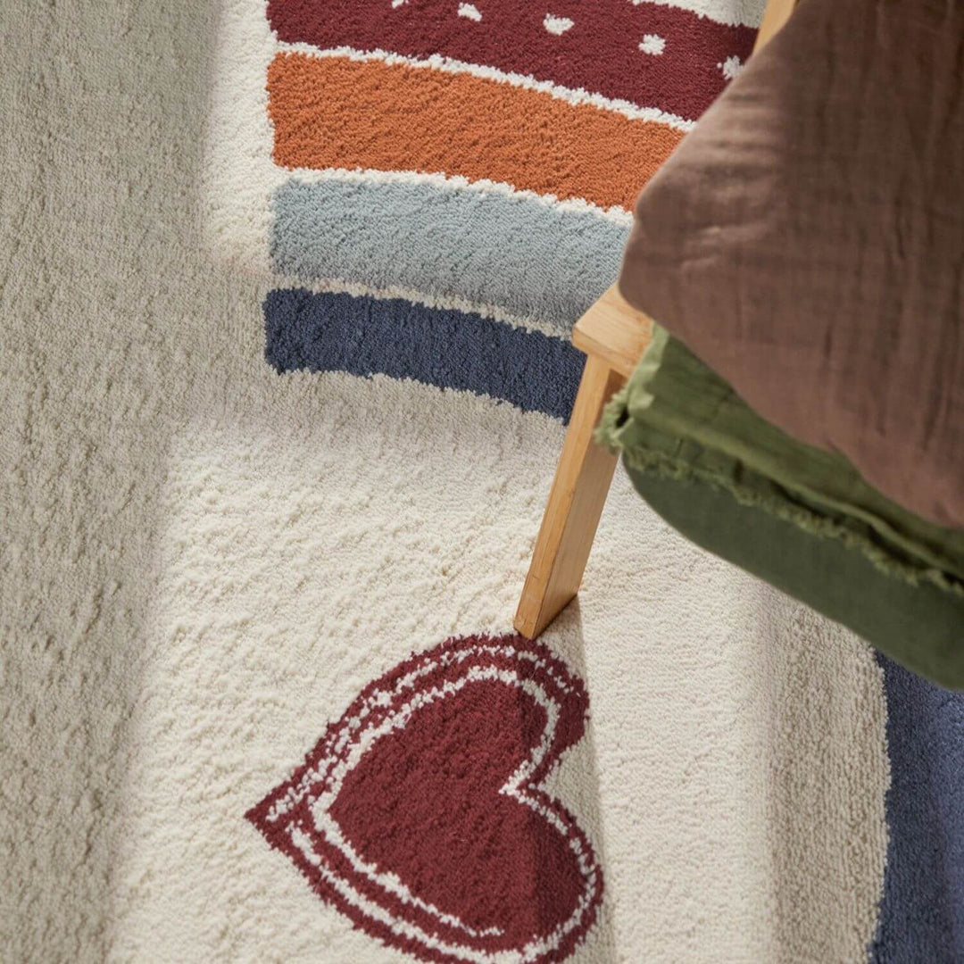 Colorful striped rug with a heart design on a neutral background