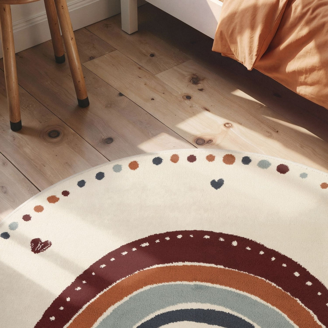 Round rug with a rainbow design on a wooden floor.