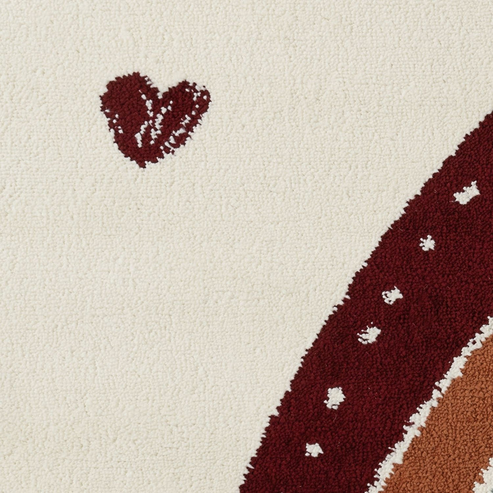 Close-up of a textured rug with a heart shape and wavy line on a beige background