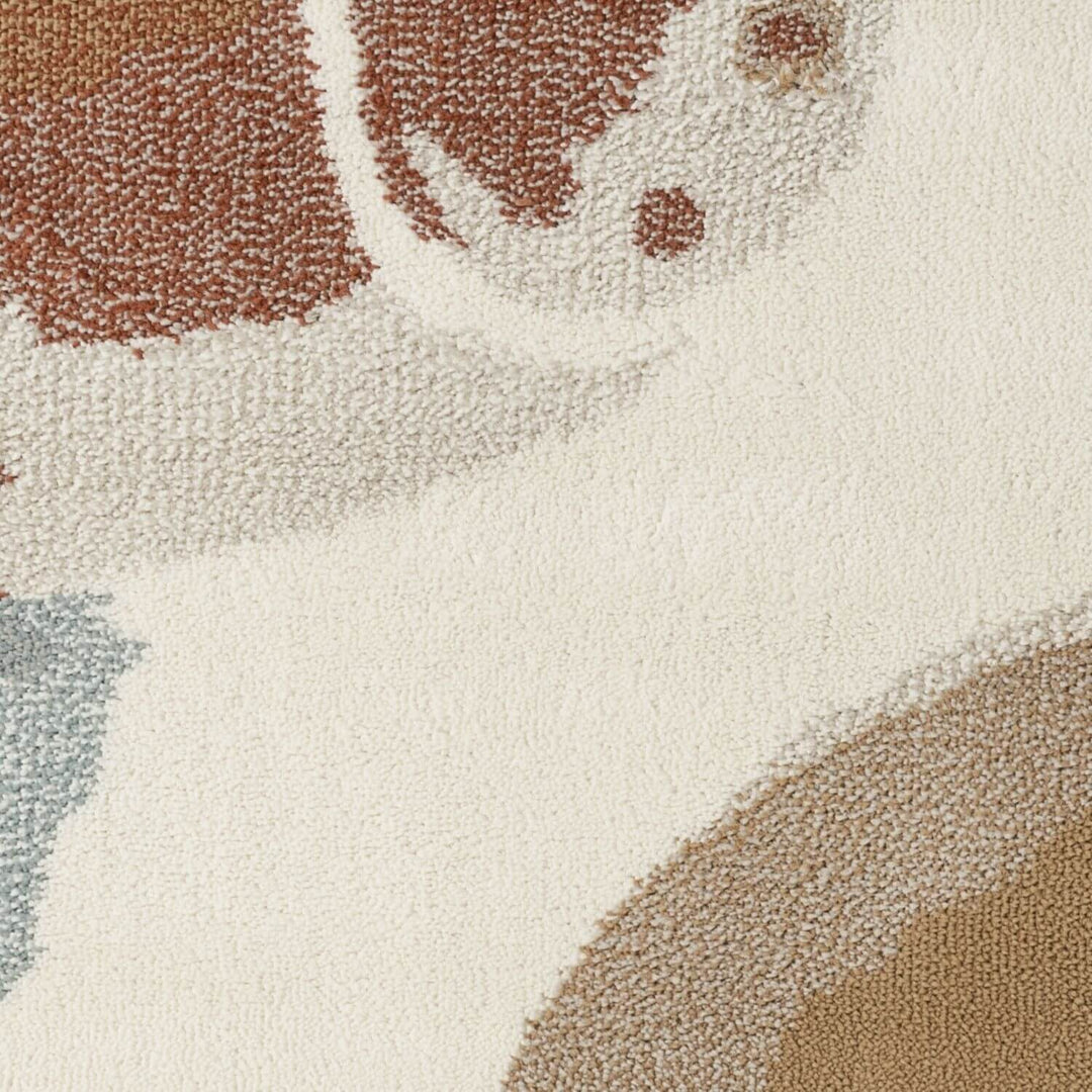 Close-up of a textured rug with brown, beige, and blue abstract pattern