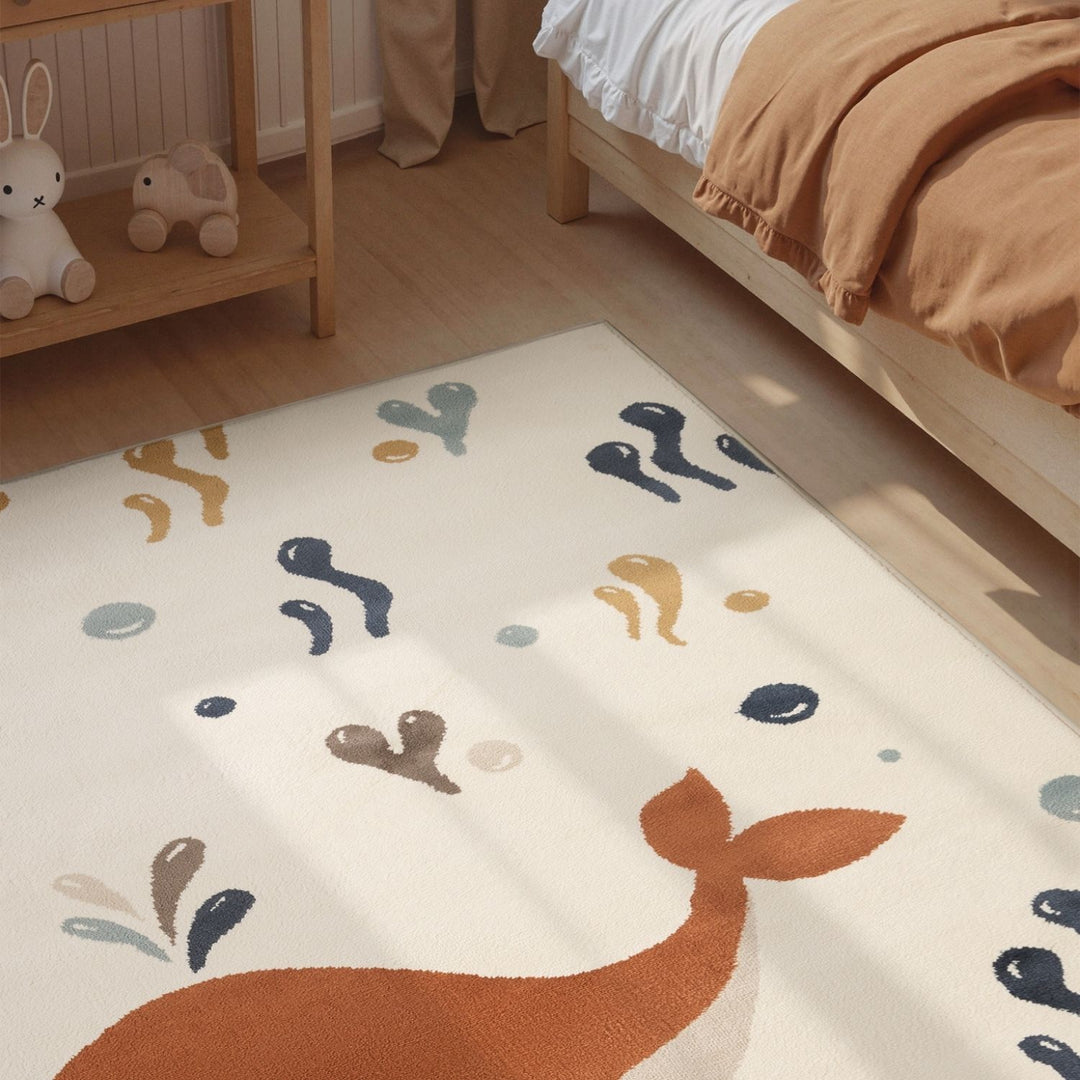 Children's room with a rug featuring animal illustrations on a wooden floor.