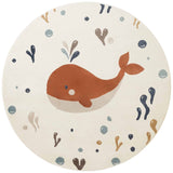 Round children's rug with a whale design on a white background