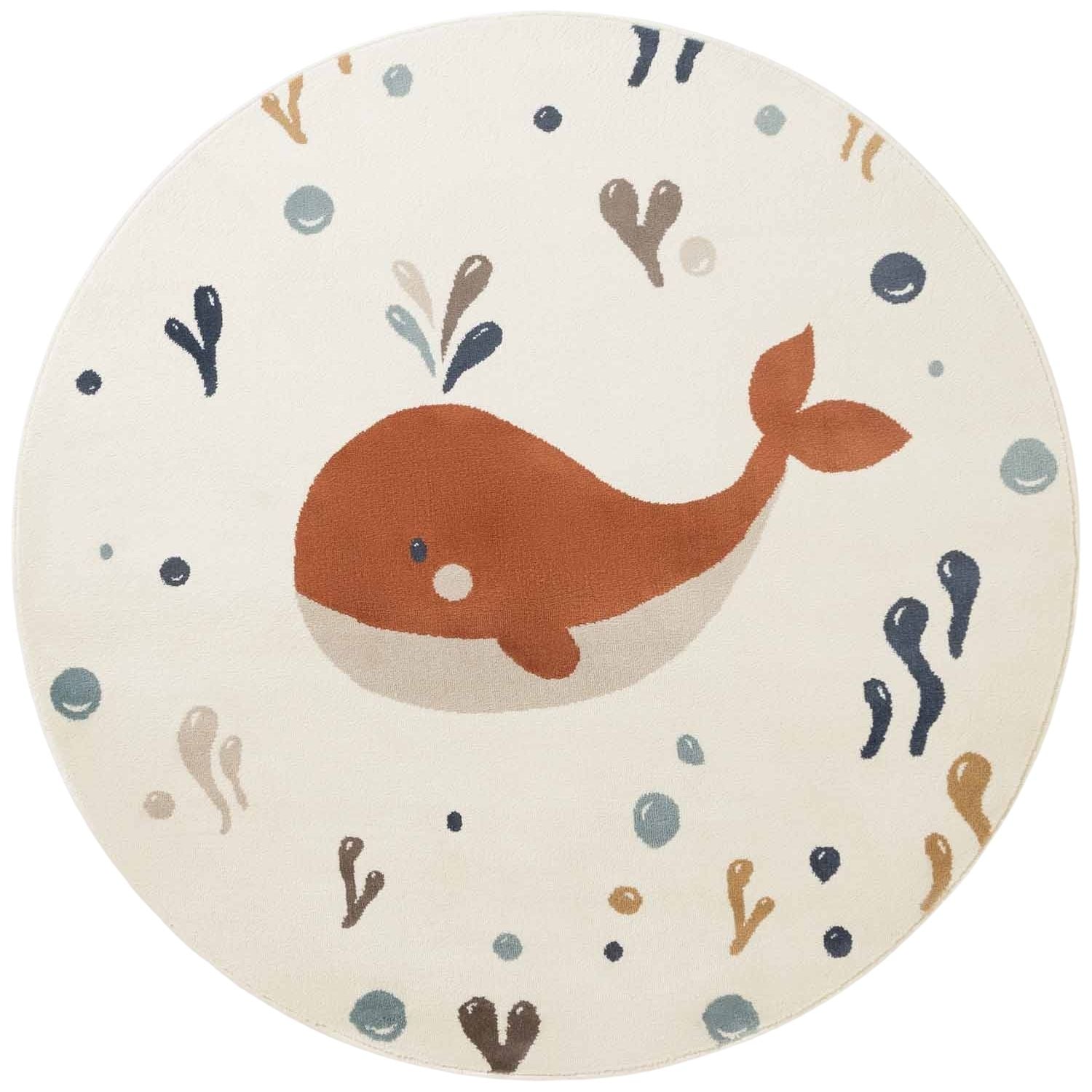 Round children's rug with a whale design on a white background