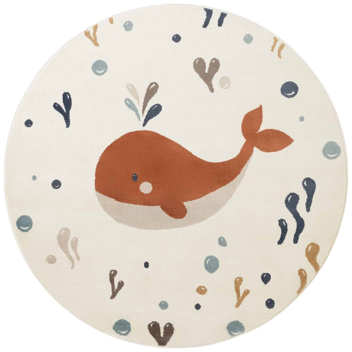 Round children's rug with a whale design on a white background