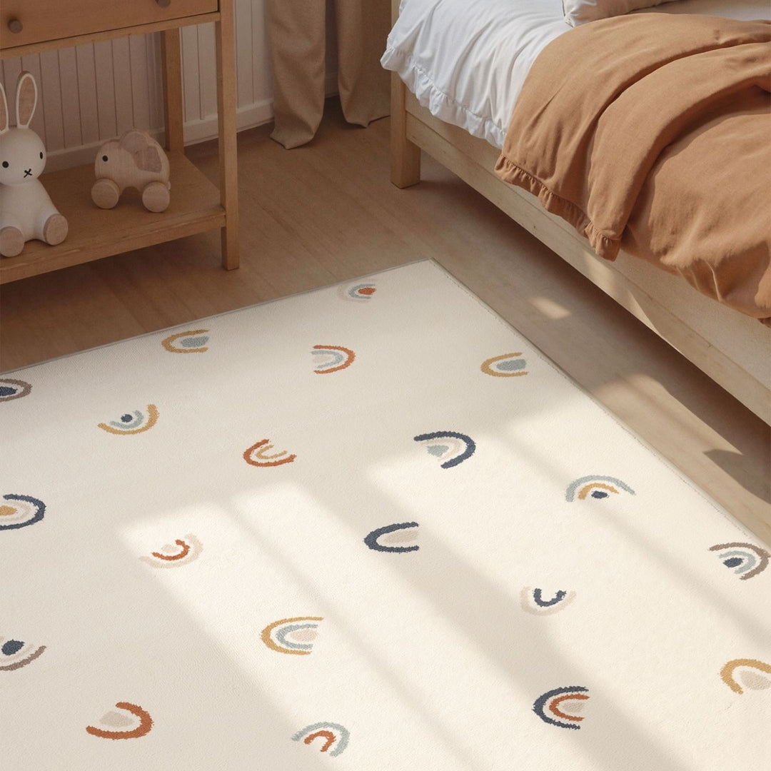 Children's room with a patterned mattress on the floor, bed, and shelf.