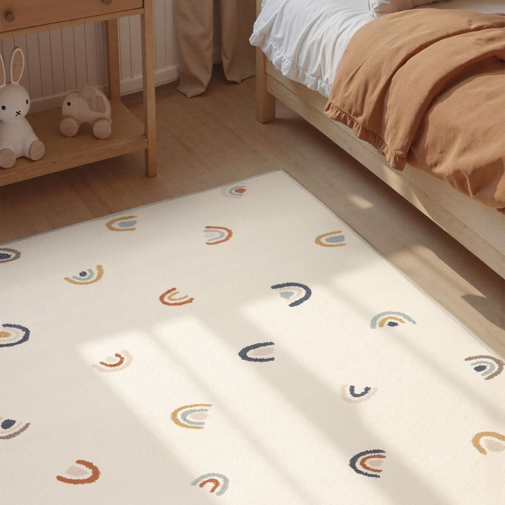 Children's room with a patterned mattress on the floor, bed, and shelf.