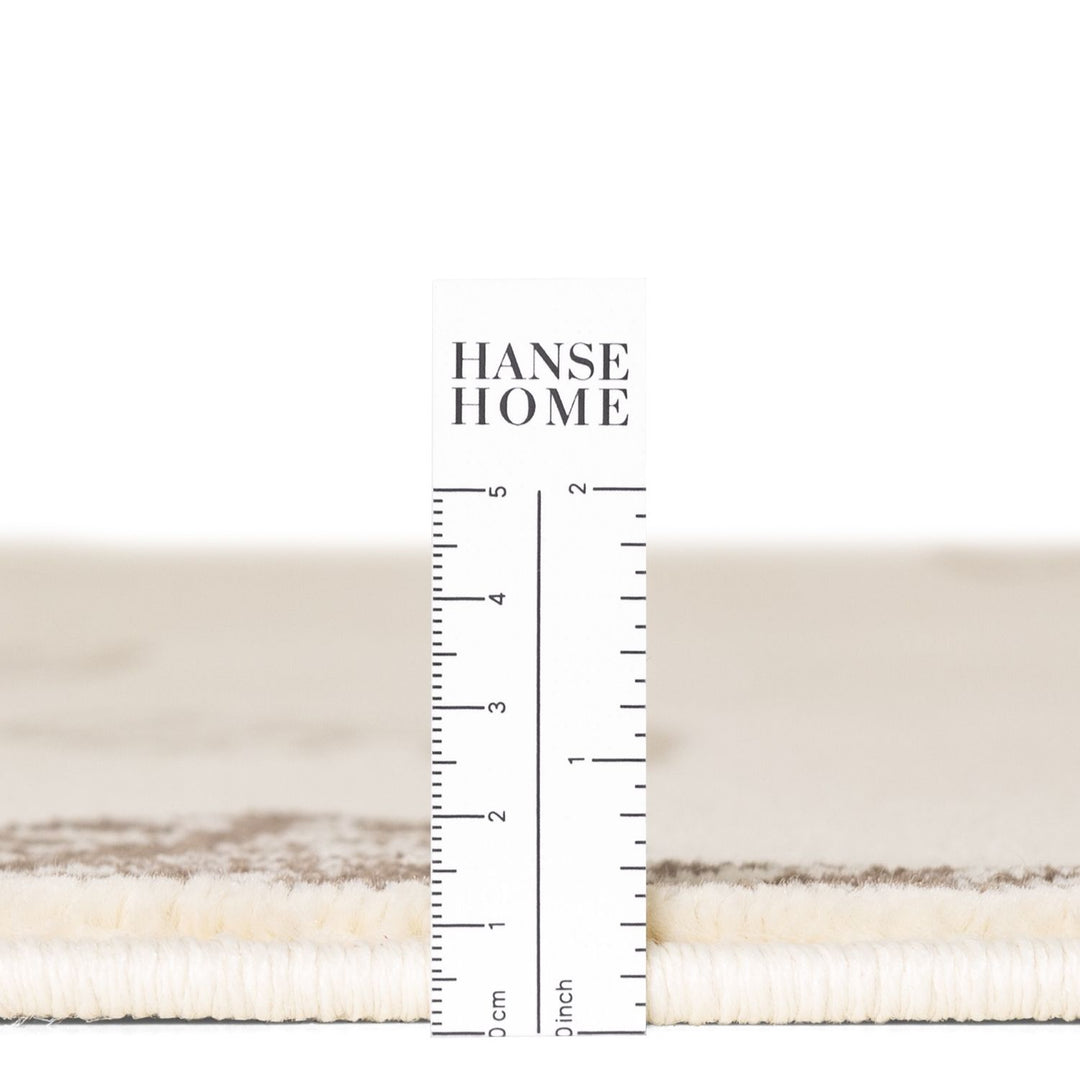 Textured fabric swatch with a ruler for measurement and 'HANSE HOME' branding.