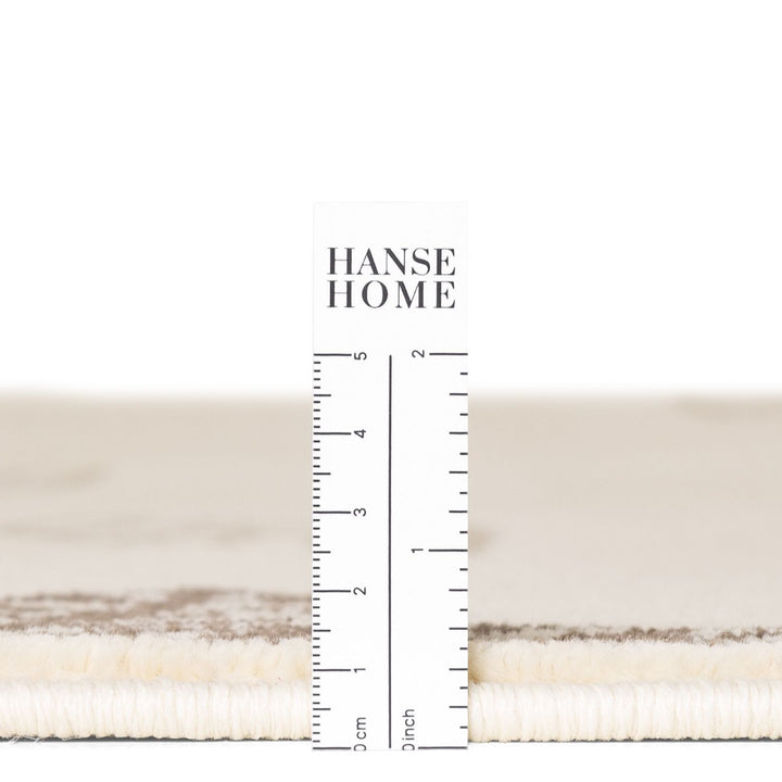 Textured fabric swatch with a ruler for measurement and 'HANSE HOME' branding.