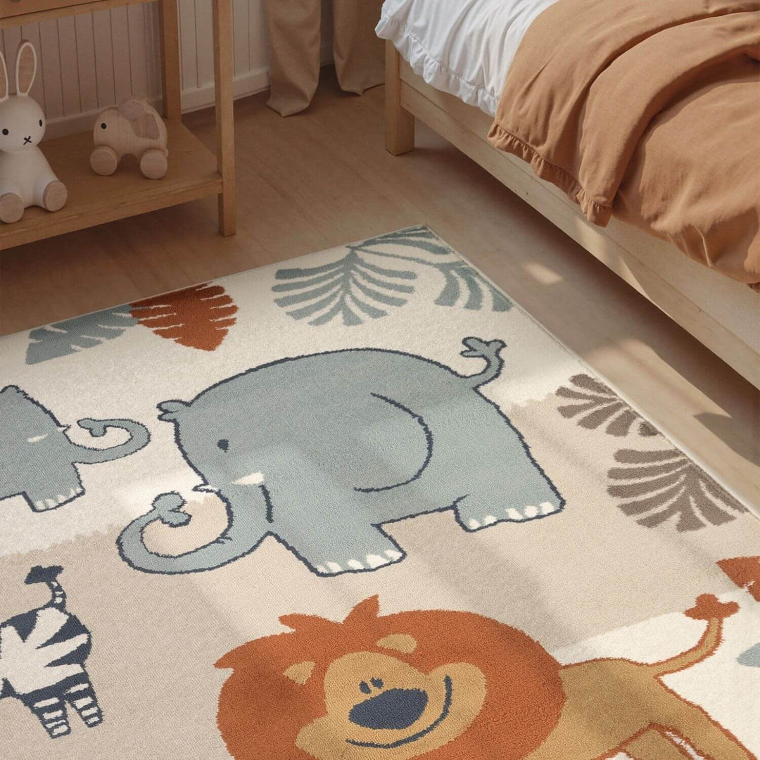 Children's room with a rug featuring cartoon animals like an elephant, lion, and zebra.
