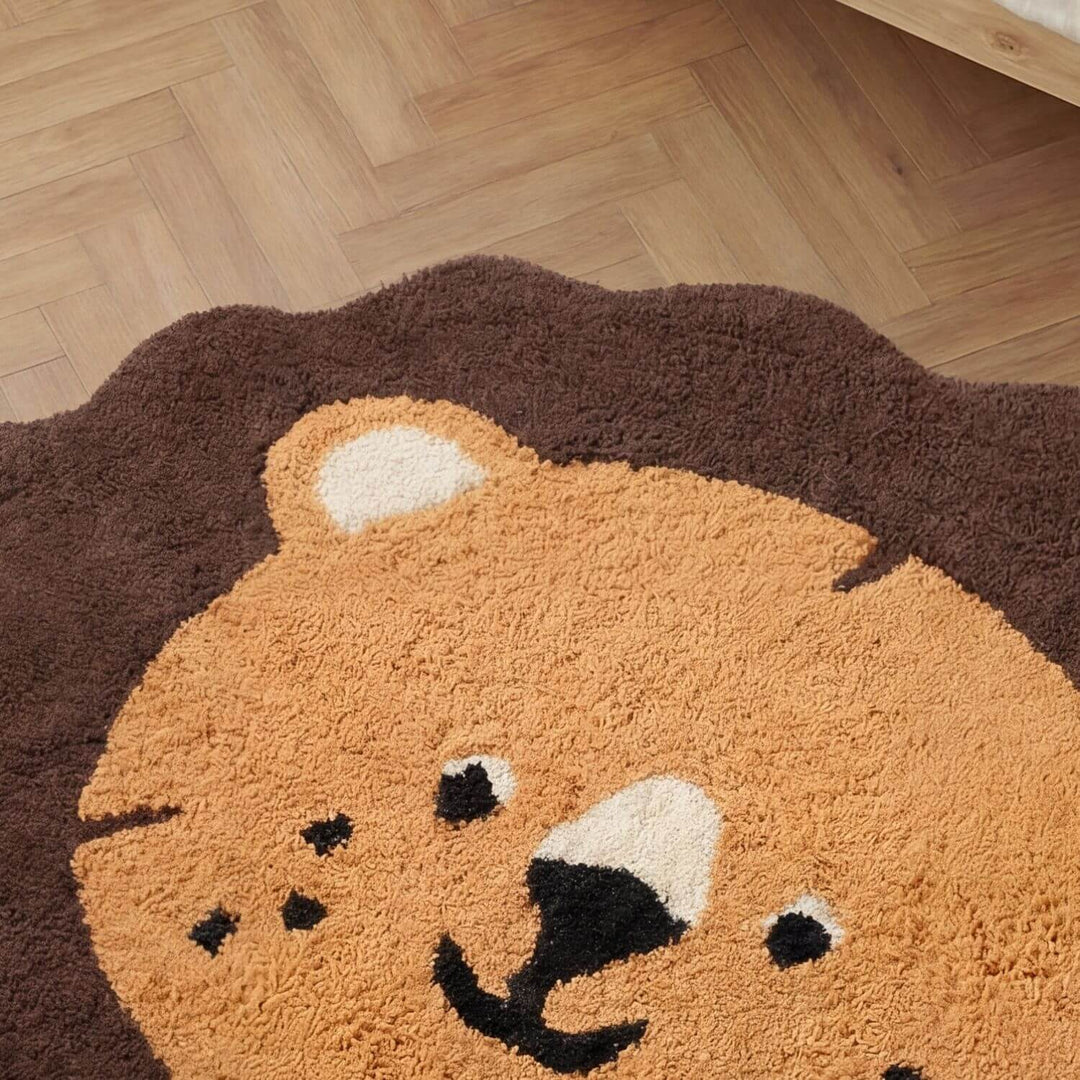 Round rug with a bear face design on a wooden floor