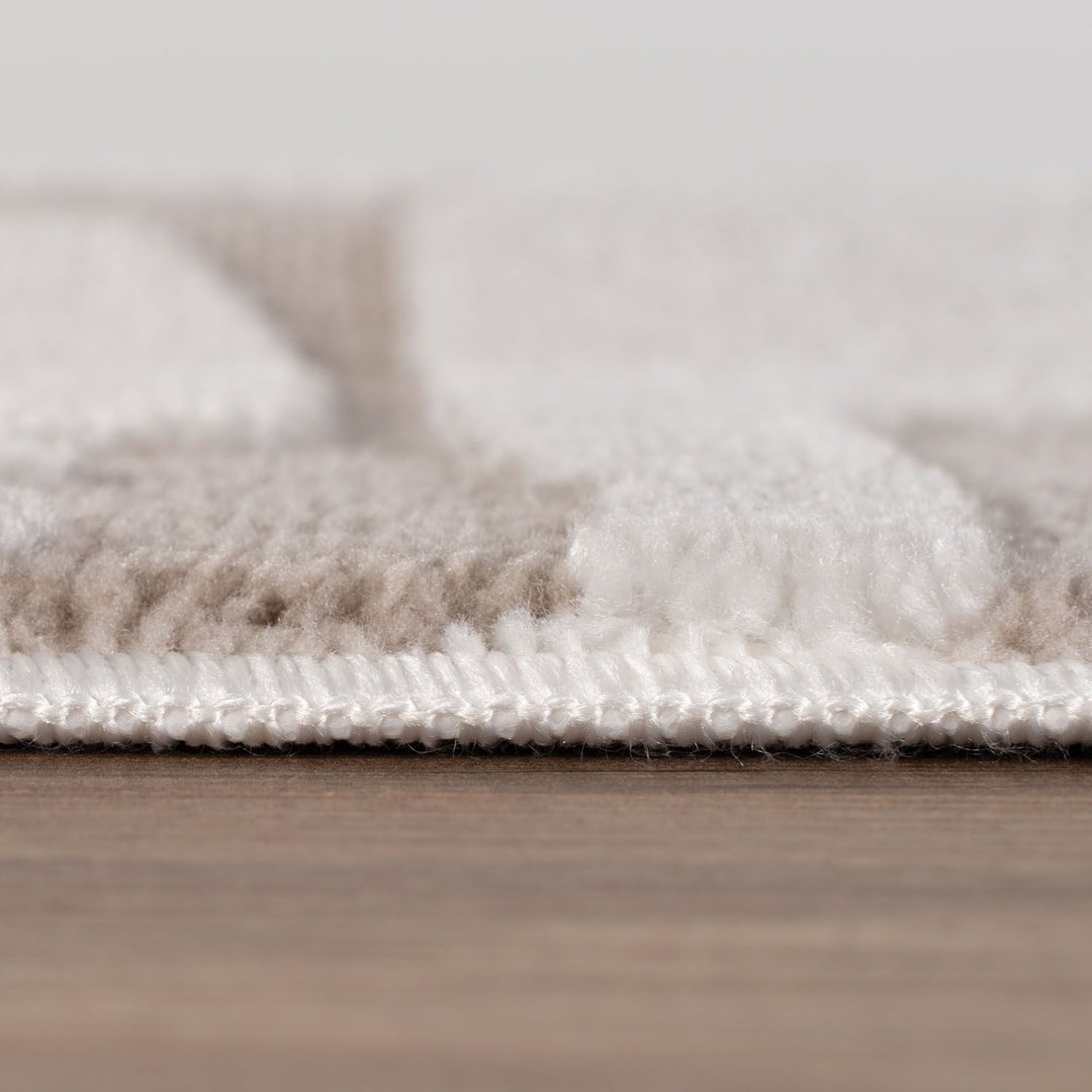 Close-up of a textured rug on a wooden floor