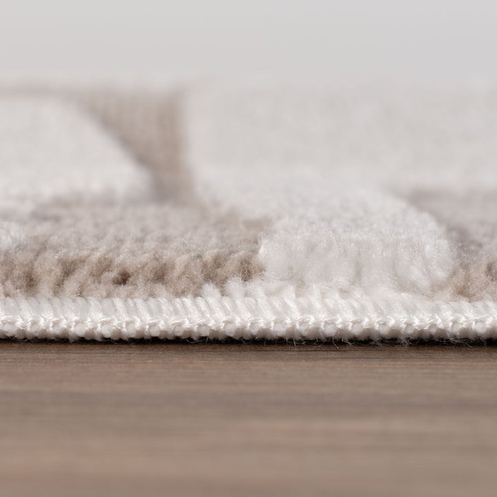Close-up of a textured rug on a wooden floor