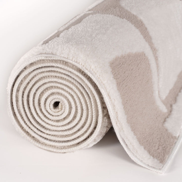 Rolled-up beige towel on a white background