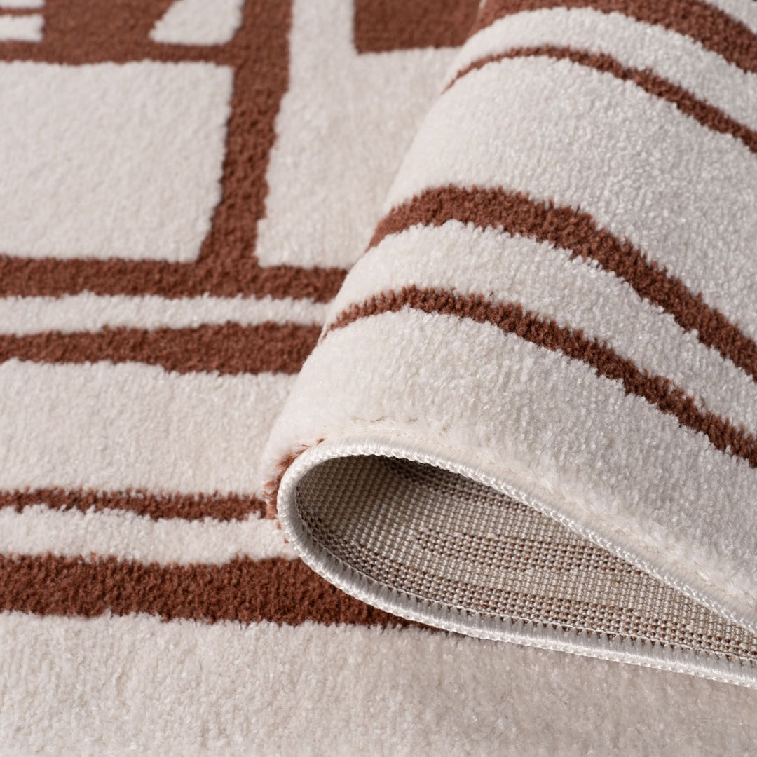Close-up of a textured rug with brown and beige stripes