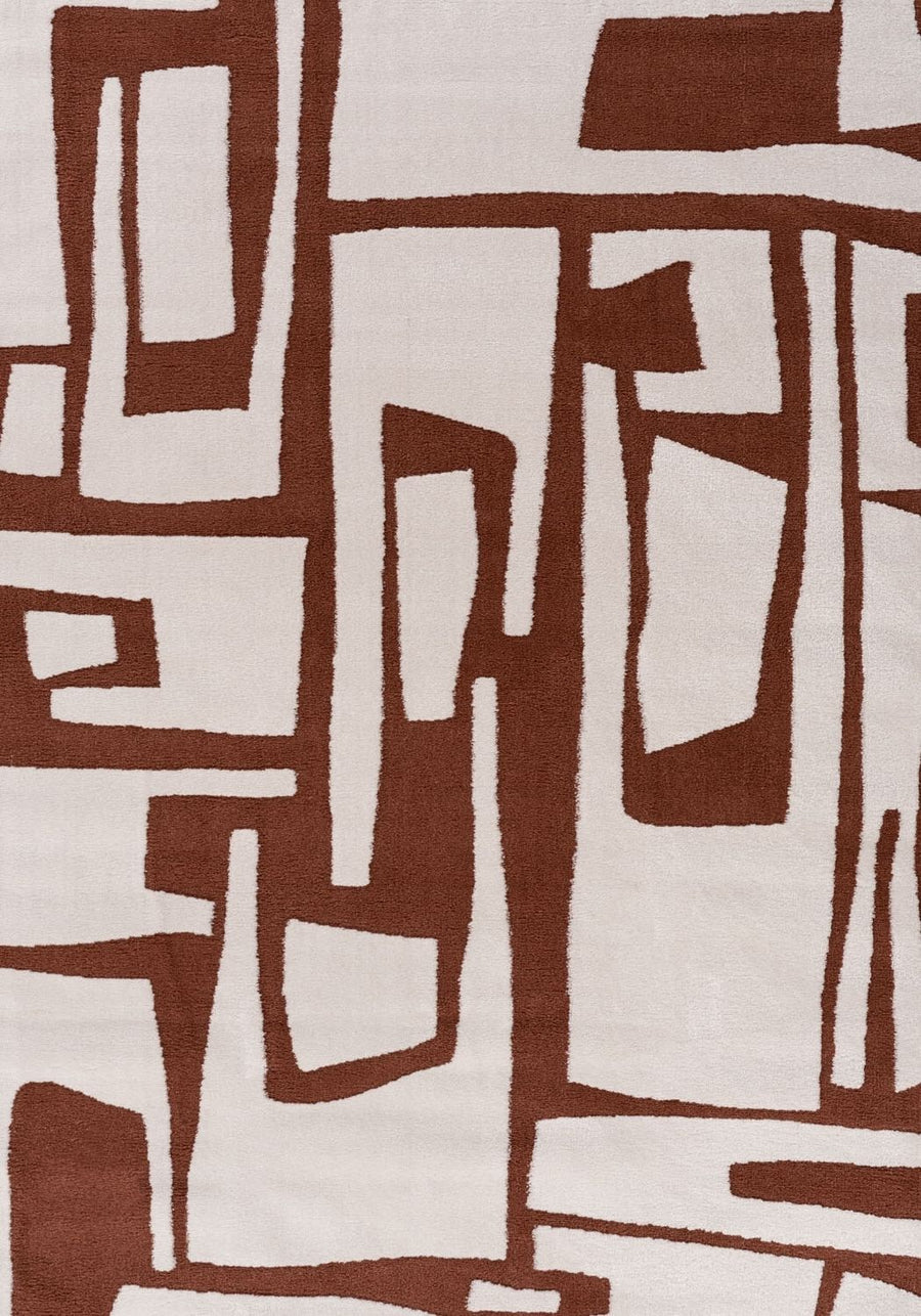 Abstract pattern of brown and beige shapes on a textured fabric background