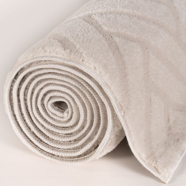 Rolled-up beige carpet on a light gray background